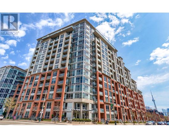 A tall building with a glass facade and a red brick exterior.