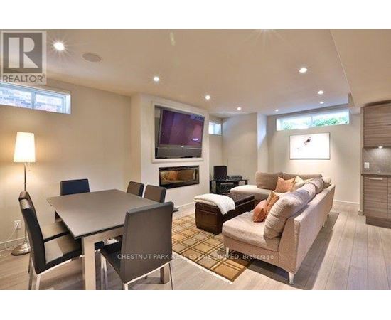 A well-lit living room with a dining table and a couch.