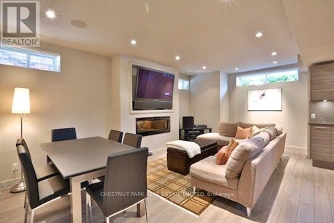 A well-lit living room with a dining table and a couch.