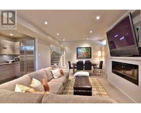 A living room with a grey couch and a television.