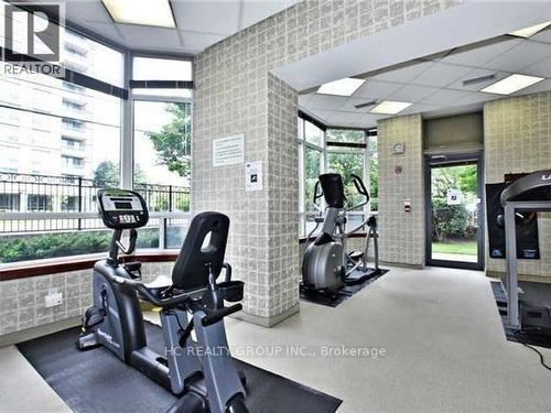 A gym with a treadmill, exercise bike and weights.