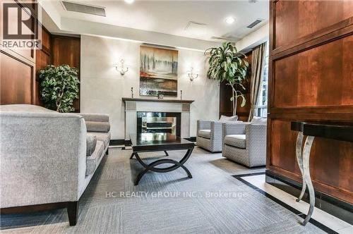 A living room with a grey sofa, a coffee table, and a fireplace.