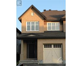 A house with a brown roof and a white garage door.