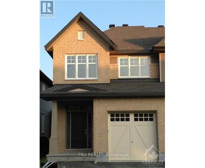 A house with a brown roof and a white garage door.