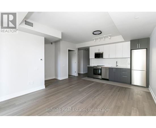 A spacious kitchen with white cabinets and stainless steel appliances.