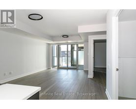 A room with a white table and a door leading to a balcony.