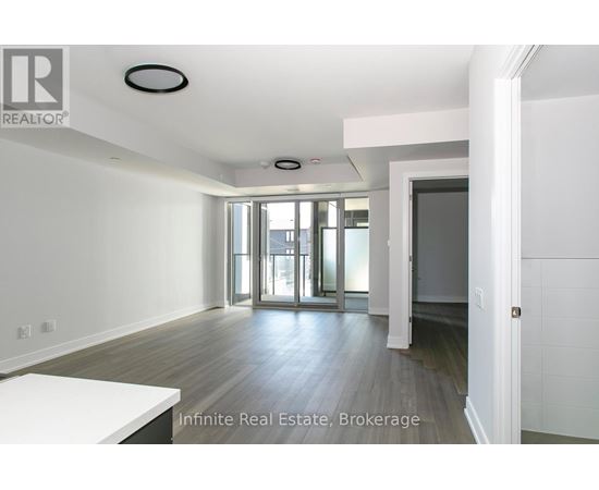 A room with a white table and a door leading to a balcony.