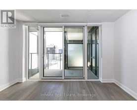 A room with a glass door leading to a balcony.
