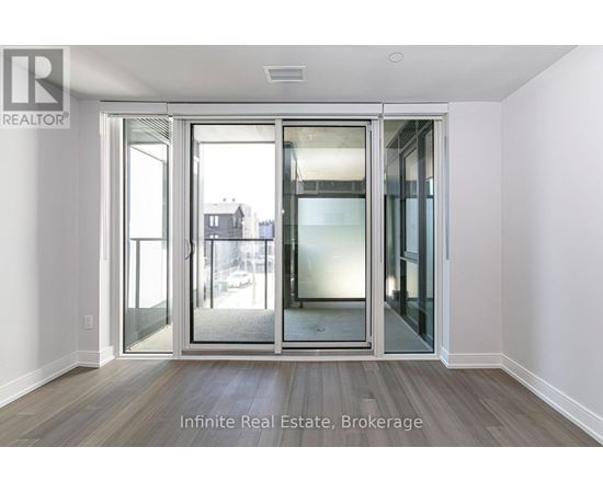 A room with a glass door leading to a balcony.