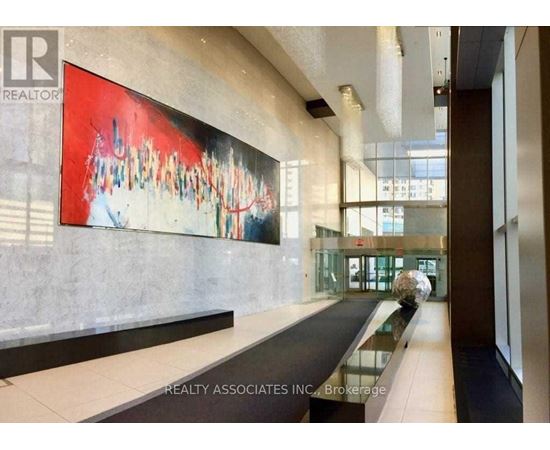 A hallway with a pool table and a painting on the wall.