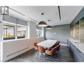 A dining room with a table and chairs.