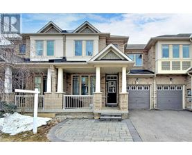 A large, two-story house with a front porch and a garage.