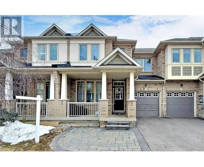 A large, two-story house with a front porch and a garage.