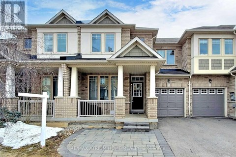 A large, two-story house with a front porch and a garage.
