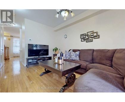 A living room with a brown couch and a wooden coffee table.