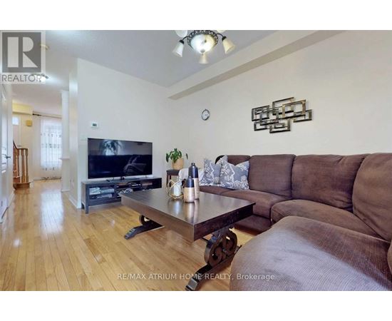 A living room with a brown couch and a wooden coffee table.