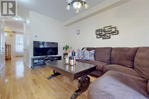 A living room with a brown couch and a wooden coffee table.