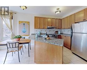 A kitchen with a table and chairs and a fridge.