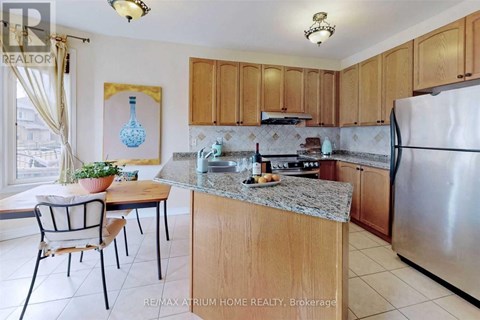 A kitchen with a table and chairs and a fridge.