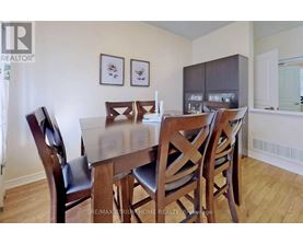 A dining room with a table and chairs.