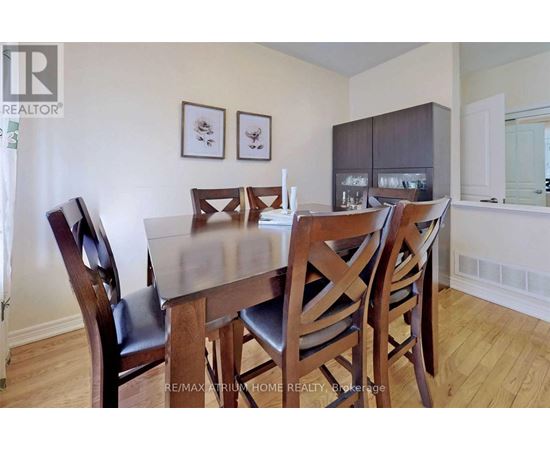 A dining room with a table and chairs.