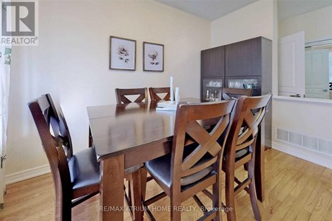 A dining room with a table and chairs.