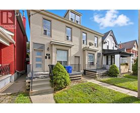 A house with a red wall and a sign that says REALTOR.