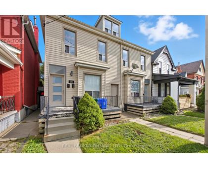 A house with a red wall and a sign that says REALTOR.