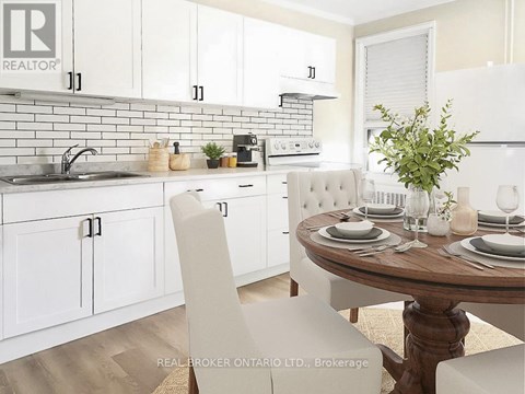 A white kitchen with a table set for two.