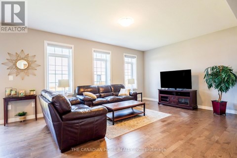 A living room with a leather couch and a flat screen TV.