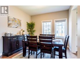 A dining room with a table set for four.