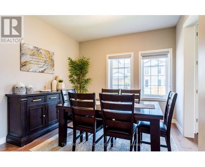 A dining room with a table set for four.