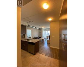 A kitchen with a sink and a dining table.