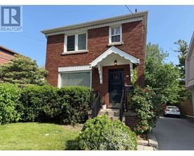 A house with a red brick exterior and a white window trim.