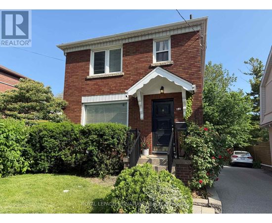 A house with a red brick exterior and a white window trim.