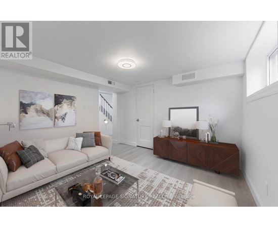 A living room with a white couch and a coffee table.