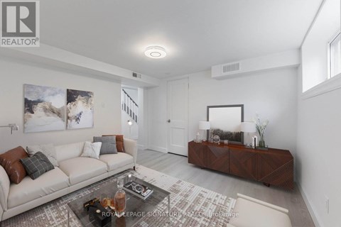 A living room with a white couch and a coffee table.
