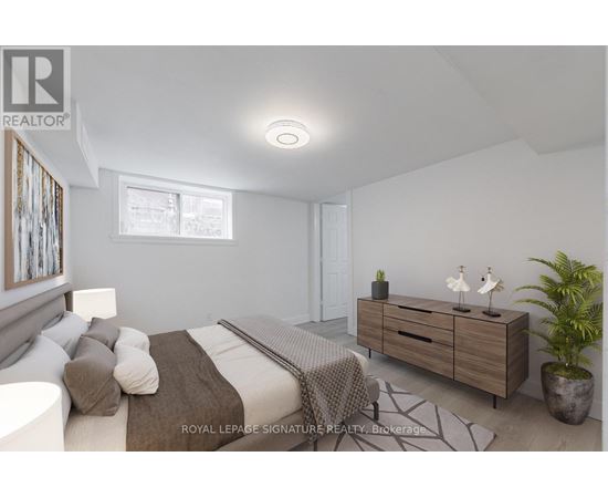 A bedroom with a bed, a dresser, and a potted plant.