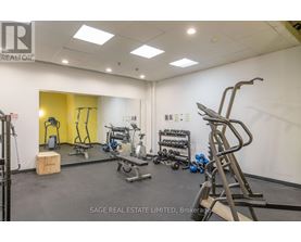 A gym with a variety of equipment including a treadmill, weights, and a bench press.