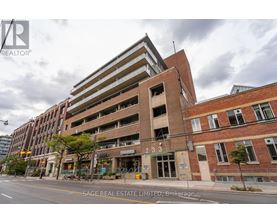 A building with the number 233 on it is for sale.