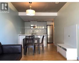 A modern kitchen with a dining table and chairs.