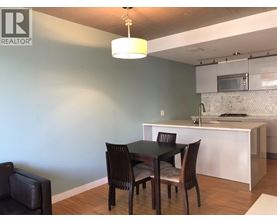 A dining room with a table and chairs.