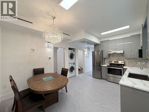 A modern kitchen with a wooden table and chairs.