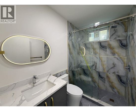 A bathroom with marble countertops and a walk-in shower.