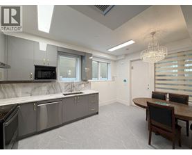 A modern kitchen with a dining table and chairs.