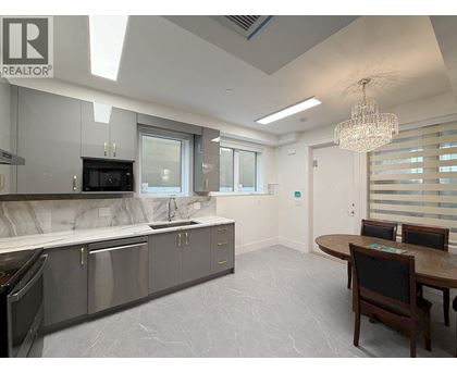 A modern kitchen with a dining table and chairs.