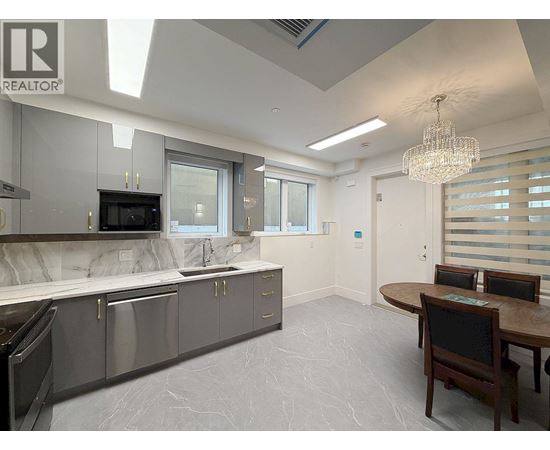 A modern kitchen with a dining table and chairs.