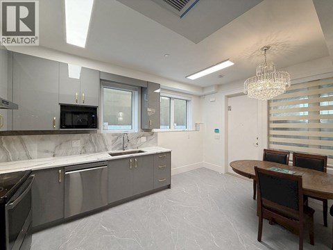 A modern kitchen with a dining table and chairs.