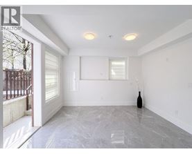 A room with a marble floor and a vase on the floor.