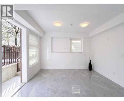 A room with a marble floor and a vase on the floor.